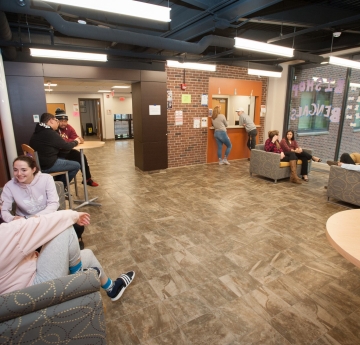 Photo of Students Sitting in the Bishop Hall Lobby